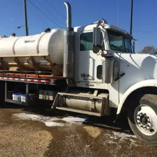 Large Welter Inc truck at a job site